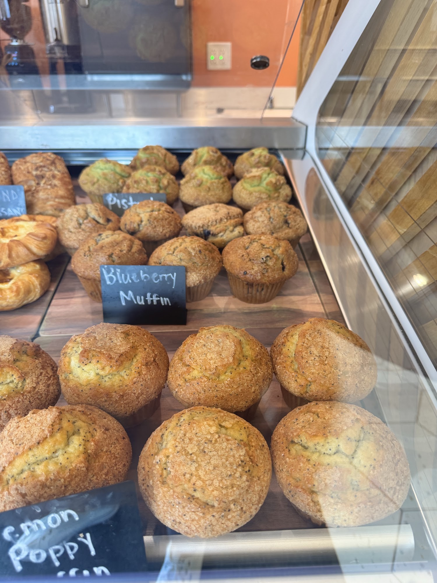 Muffins in Viza Cafe pastry display case